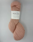 Single skein of pink yarn with a Pickles label on a light gray background