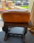 Brown leather Re:Designed project 41 bag on a wooden stand.