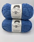 Two blue skeins of yarn with labels on a gray background