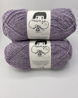 Two skeins of purple yarn with labels on a white background