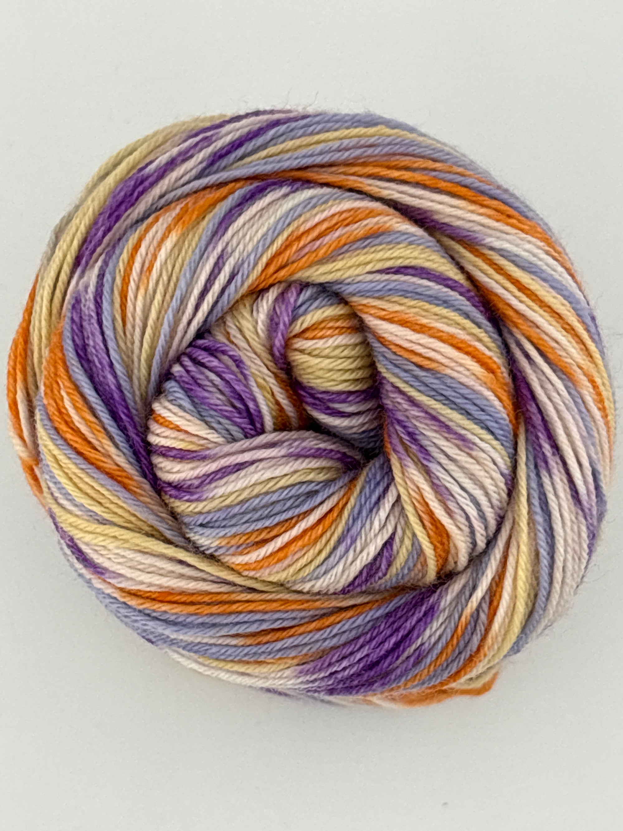 Multicolored skein of yarn on a light gray background