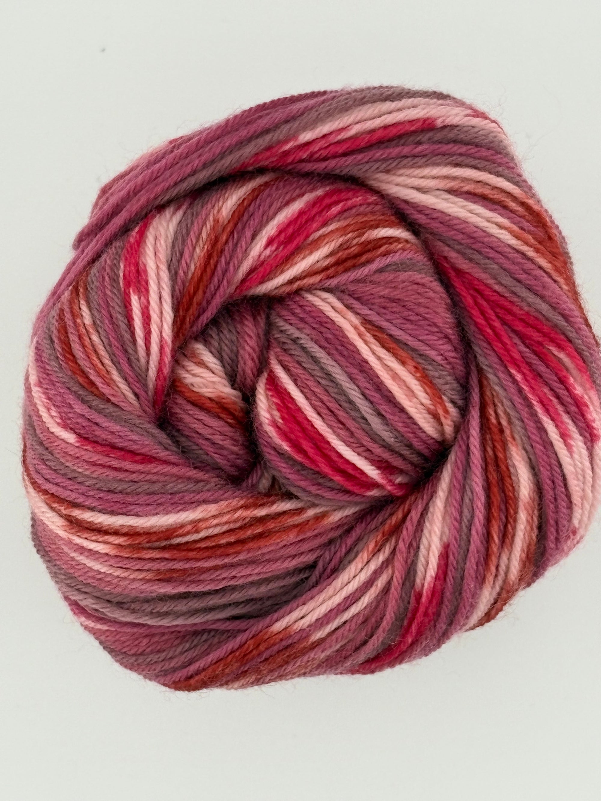 Multicolored skein of yarn on a light gray background