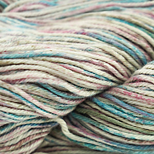 A close-up image of a multicolored worsted weight yarn skein with vibrant splashes of red, blue, and green.
