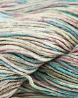 A close-up image of a multicolored worsted weight yarn skein with vibrant splashes of red, blue, and green.