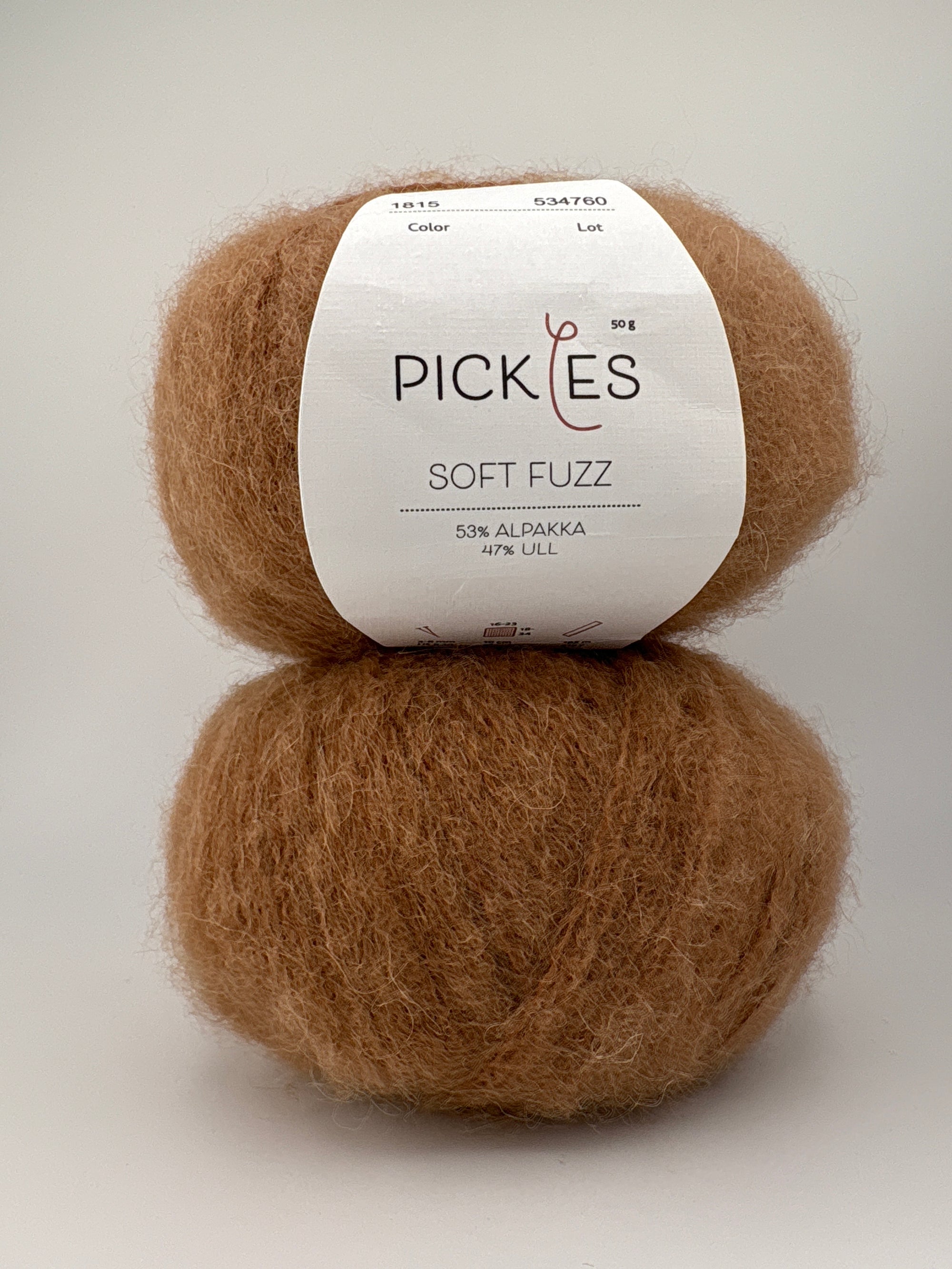 Two balls of brown yarn with a Pickles label on a light gray background