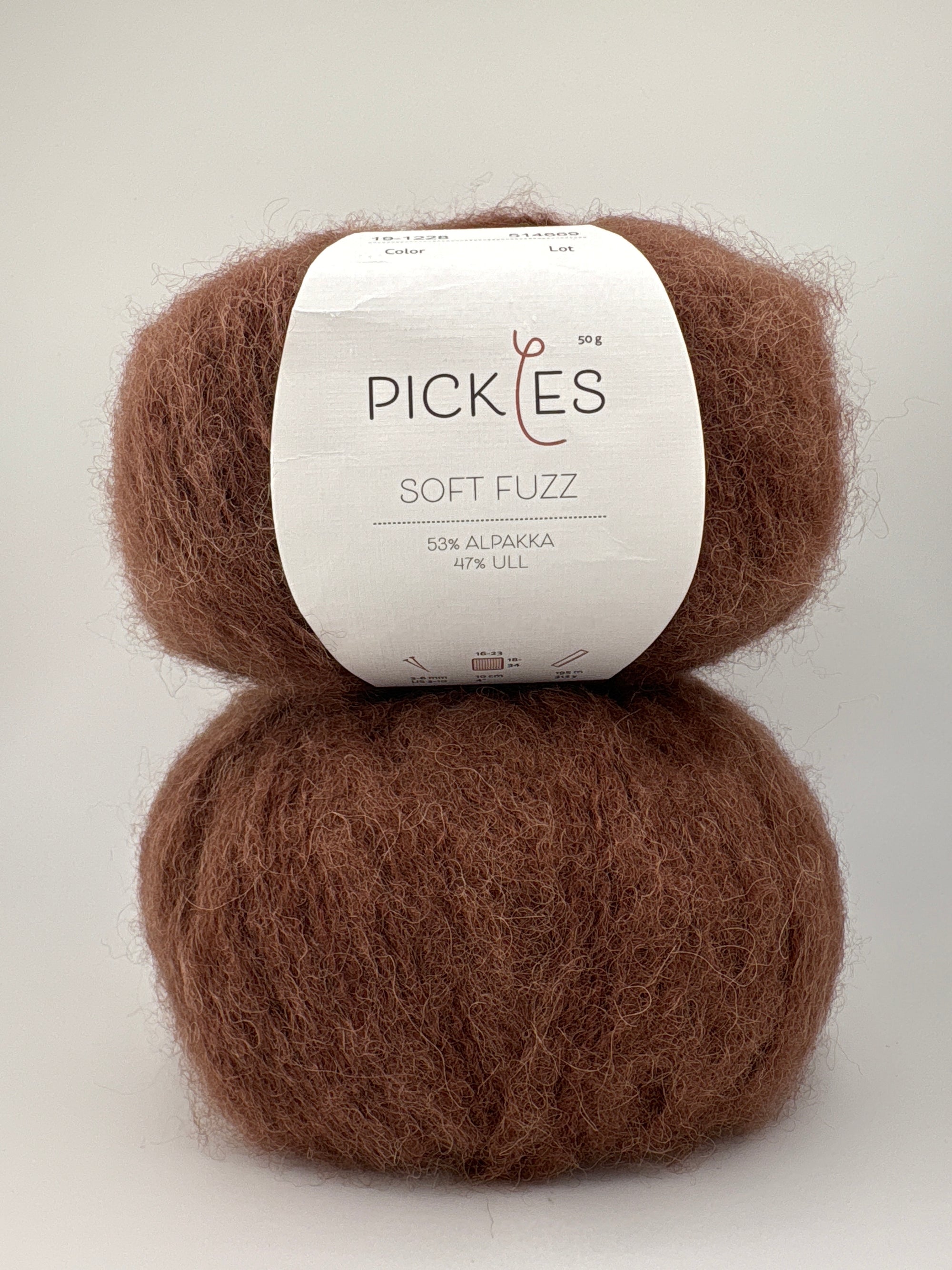 Two skeins of brown yarn with a Pickles label on a white background
