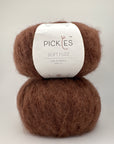 Two skeins of brown yarn with a Pickles label on a white background