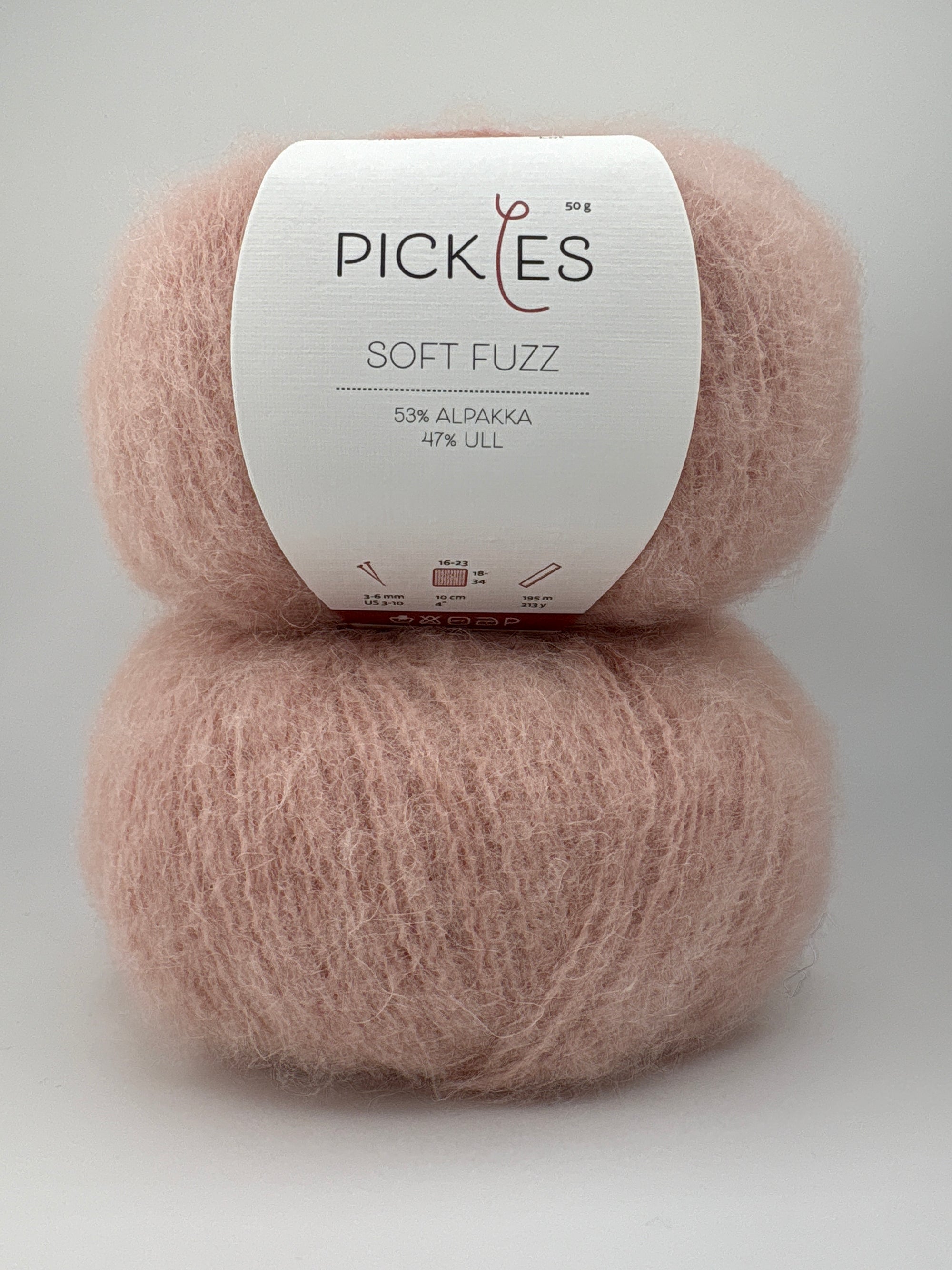 Two skeins of pink yarn with a Pickles label on a white background