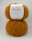 Ball of orange yarn with a Pickles label on a white background