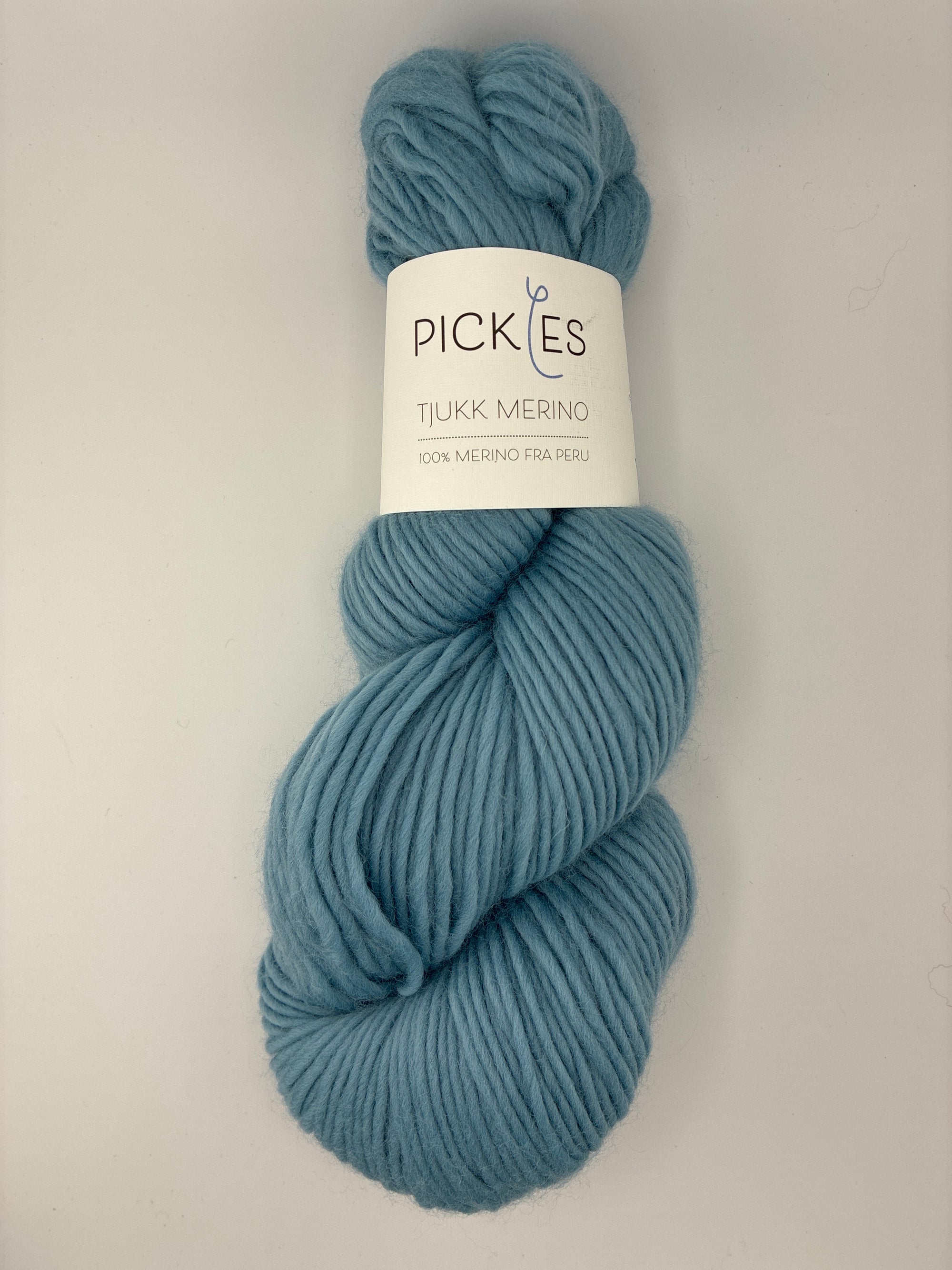 Blue skein of yarn with a Pickles label on a white background