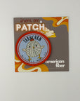 Scout Bag Patch on a card with 'American Fiber' branding on a gray background