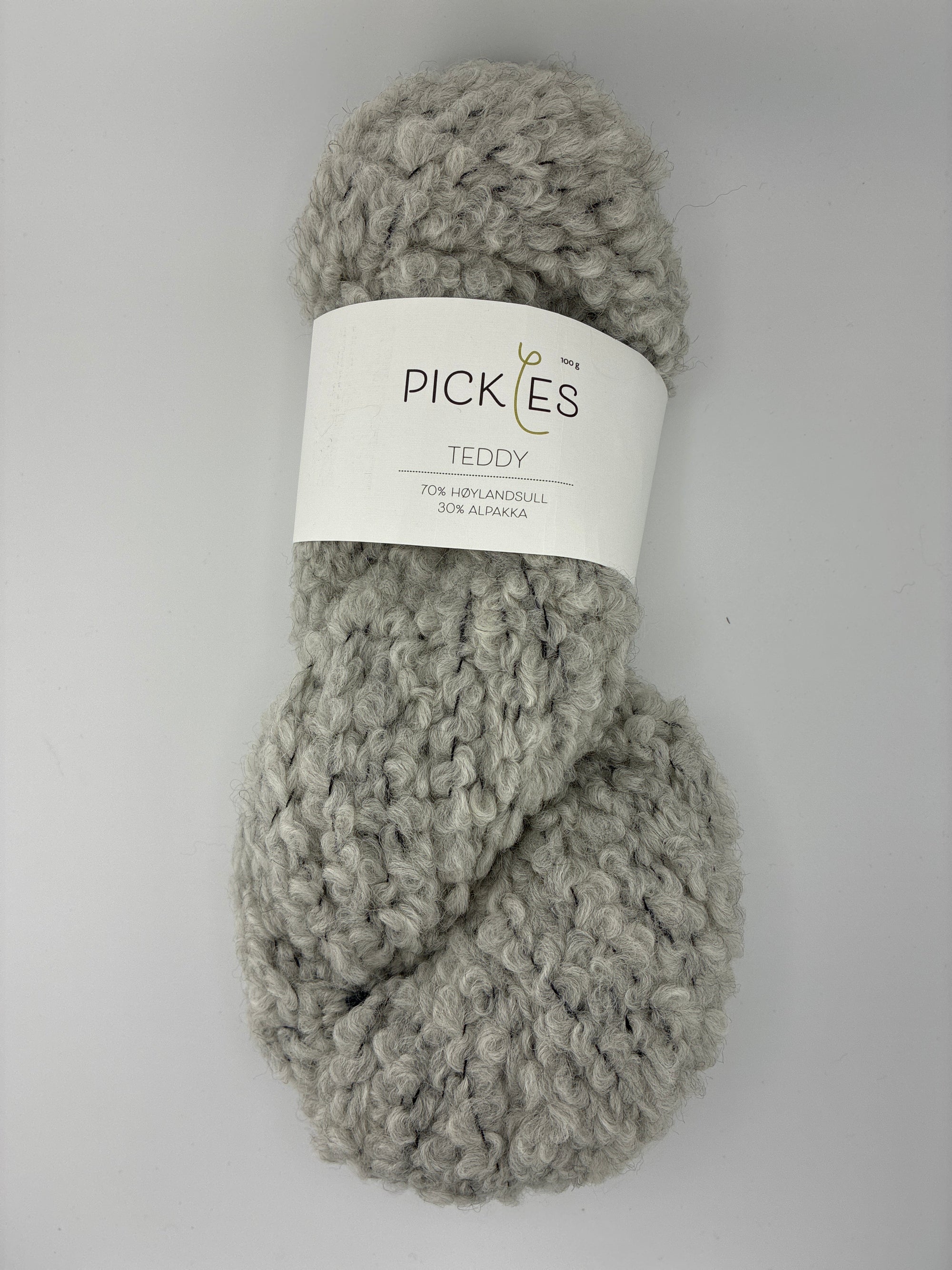 Gray skein of boucle yarn with a Pickles label on a white background