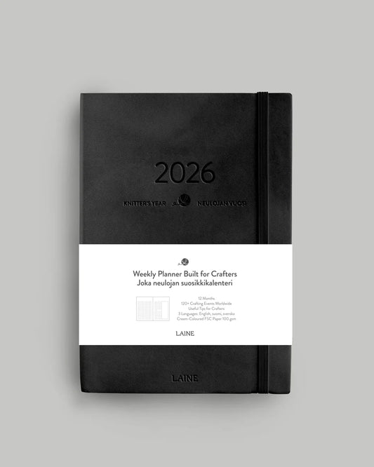 Black weekly knitting planner with '2026' on a gray background